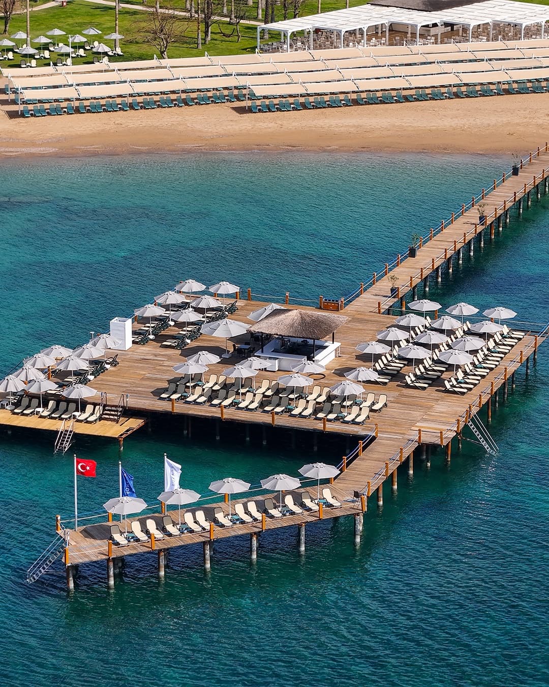 Pier with sun loungers and the beach, from above